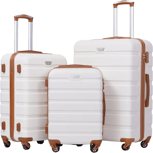 A set of three white hard-shell suitcases with brown accents, varying in size, proudly stands among our weekly best sellers. Each suitcase features a telescopic handle and four wheels for easy mobility, neatly aligned side by side.